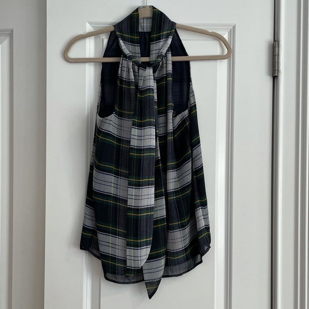 Sleeveless, tartan top with tie in back.